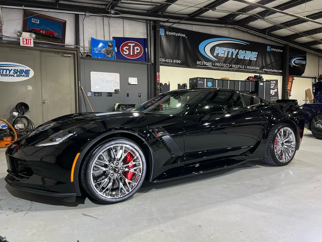 Black Chevrolet Corvette Grand Sport inside the Petty Shine shop after ceramic coating
