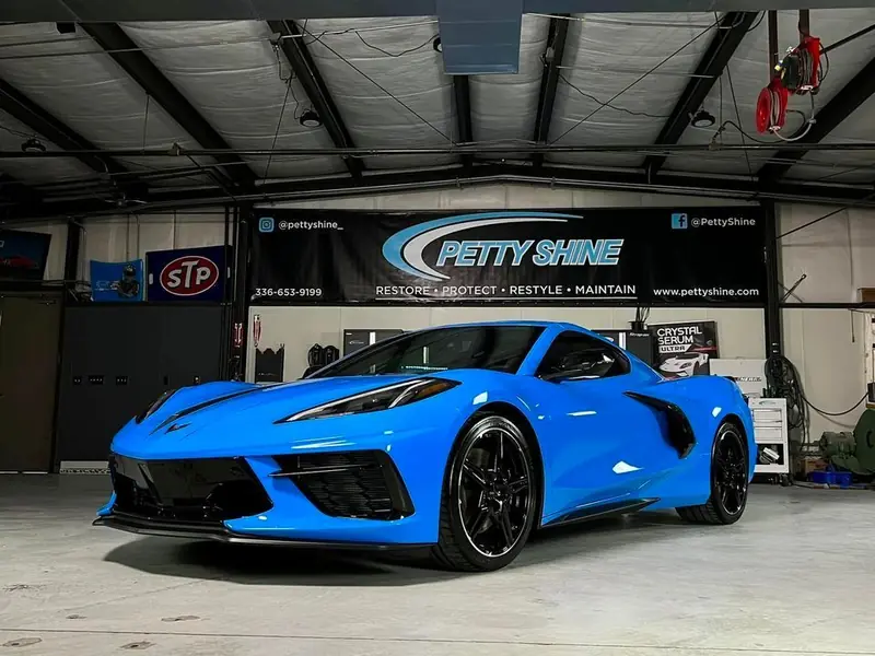 Side profile of a Rapid Blue Corvette C8 after paint correction and ceramic coating