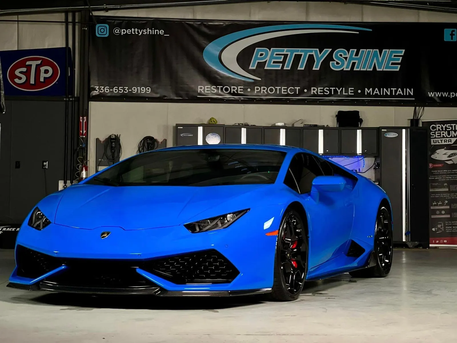 Blue Lamborghini Huracan under the Petty Shine banner after ceramic coating