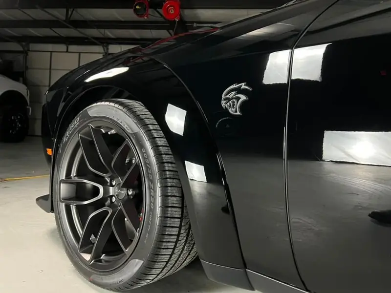 Mirror reflections in black paint after a full paint correction at Petty Shine