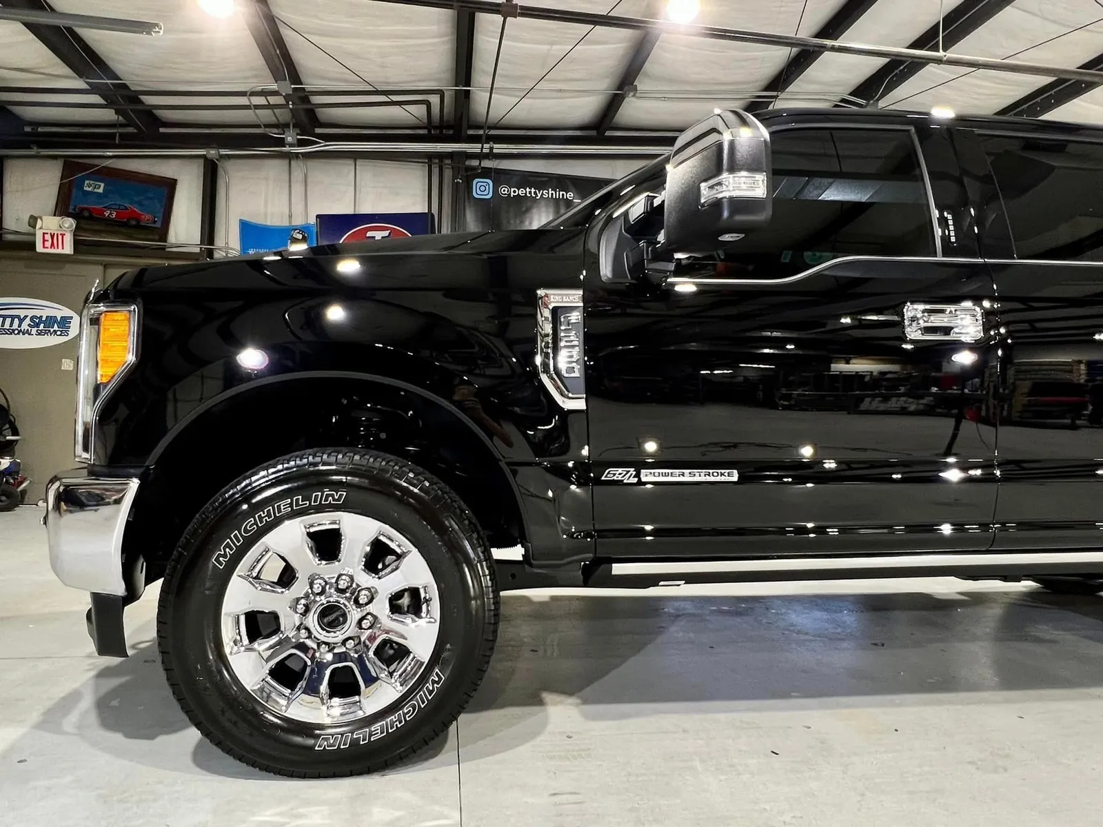 Black Ford F-250 Super Duty inside the Petty Shine shop after paint correction