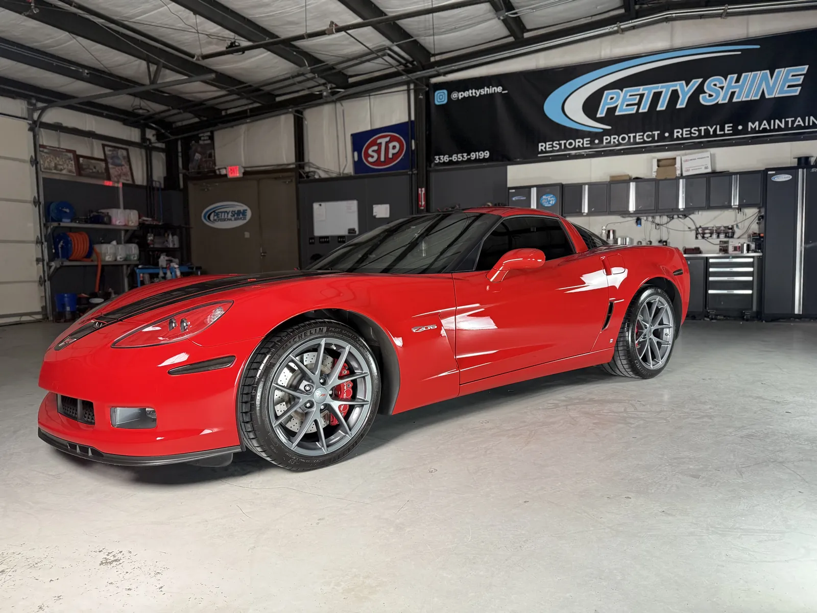 Red Chevrolet Corvette C6 Z06 under the Petty Shine banner in the Randleman shop