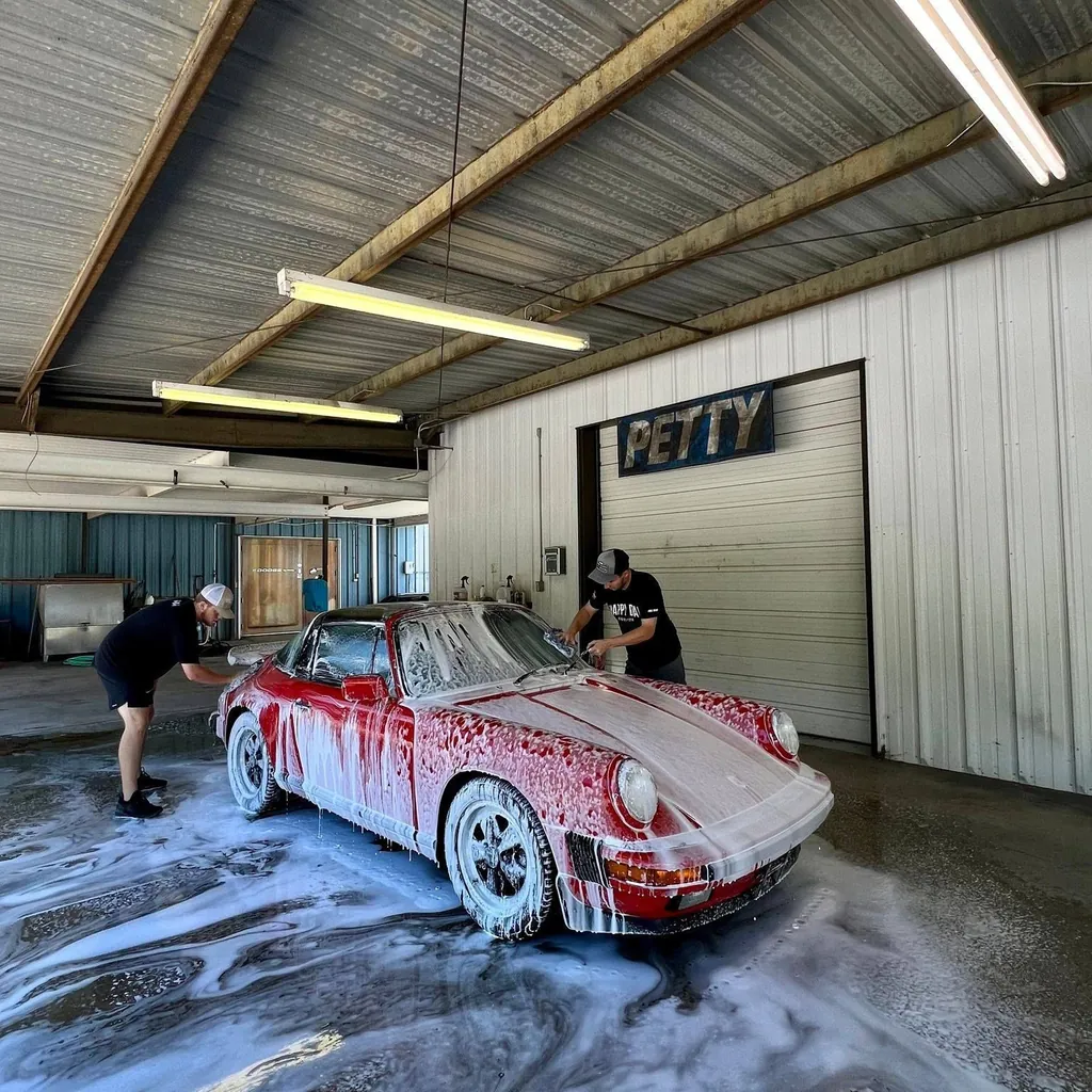 Red Porsche 911 being washed inside the Petty Shine shop in Randleman